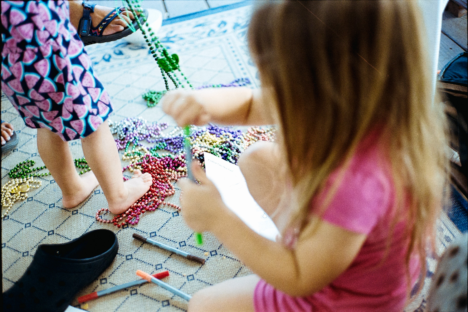Candid photo of children playing with colorful beads
